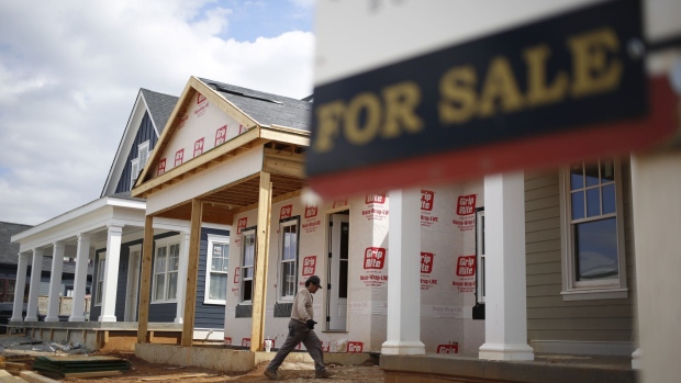 A contractor walks past a "For Sale" sign while working on a home under construction in the Norton Commons subdivision in Louisville, Kentucky, U.S., on Monday, March 23, 2020. Purchases of new U.S. homes in February held close to an almost 13-year high, showing momentum in the residential real estate market before economic activity fell victim to the coronavirus. Photographer: Luke Sharrett/Bloomberg