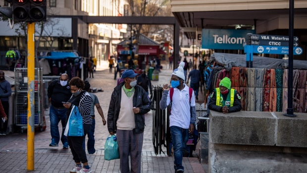 Pedestrians wait to cross Adderley Street in central Cape Town on July 23. Photographer: Dwayne Senior/Bloomberg