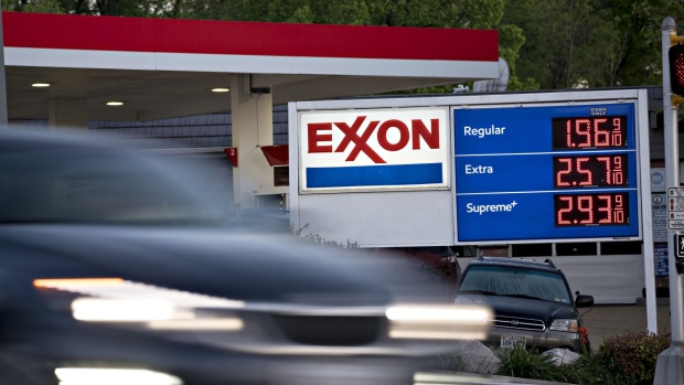 A vehicle passes an Exxon Mobil Corp. gas station in Arlington, Virginia, U.S., on Wednesday, April 29, 2020. Exxon is scheduled to released earnings figures on May 1.
