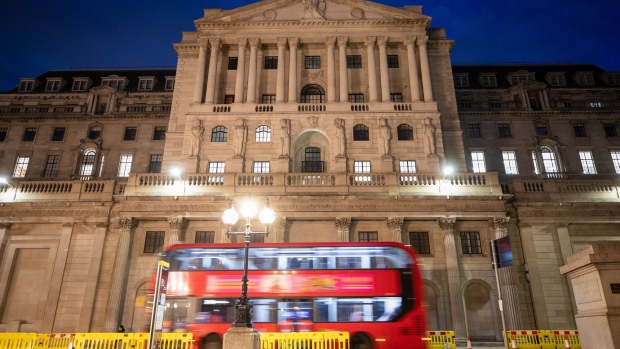 A double-decker bus passes the Bank of England in London. Photographer: Simon Dawson/Bloomberg