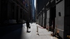 A pedestrian walks along Wall Street near the New York Stock Exchange (NYSE) in New York, U.S., on Monday, July 20, 2020. U.S. stocks fluctuated in light trading as investors are keeping an eye on Washington, where lawmakers will begin hammering out a rescue package to replace some of the expiring benefits earlier versions contained.
