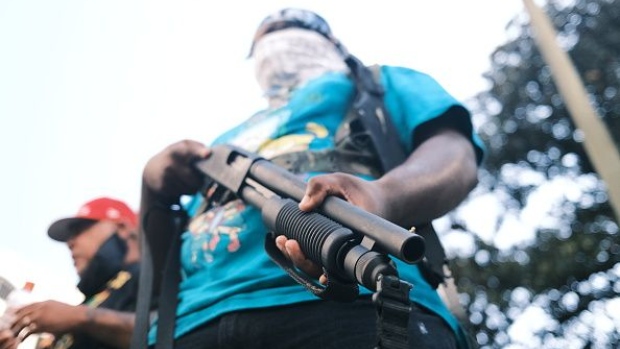 RICHMOND, VA - JULY 04: A protester carries a gun during an open carry protest on July 4, 2020 in Richmond, Virginia. People attended an event in Virginia tagged Stand with Virginia, Support the 2nd amendment. (Photo by Eze Amos/Getty Images)