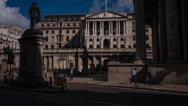 A pedestrian walks past the Bank of England (BOE) in the City of London, U.K., on Tuesday, Aug. 4, 2020. Bank of England officials could signal on Thursday that the case for more monetary stimulus is growing as a nascent rebound from the pandemic-induced recession risks fading.