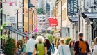 Pedestrians walk down a shopping street in Stockholm, on Aug 6. 