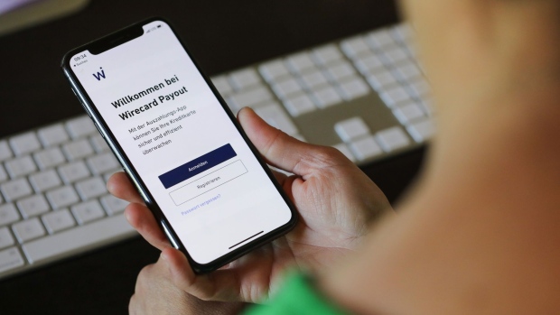 The Wirecard AG payment app log in screen is displayed on an Apple Inc. iPhone X smartphone in this arranged photograph in Frankfurt, Germany, on Tuesday, June 30, 2020. Singapore’s financial regulators are working with local police to scrutinize aspects of the case surrounding Wirecard AG, the scandal-ridden German payments company. Photographer: Alex Kraus/Bloomberg