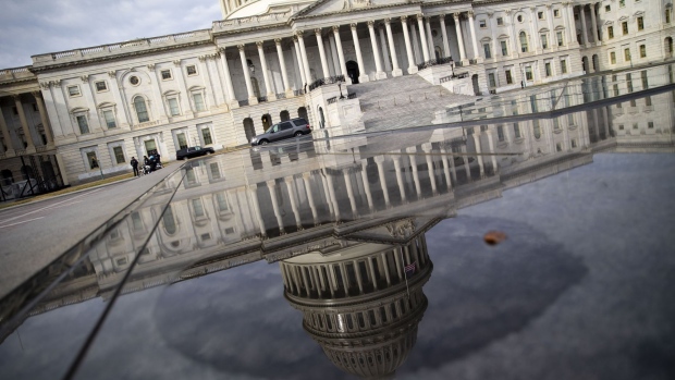 The U.S. Capitol building is reflected in a pool in Washington, D.C. Photographer: Al Drago/Bloomberg