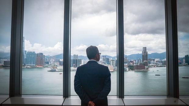Paul Chan, Hong Kong's financial secretary, looks out at the city's skyline while posing for a photograph following a Bloomberg Television interview in Hong Kong, China, on Friday, June 5, 2020. Hong Kong is ready to defend the currency’s link to the U.S. dollar with the support of the mainland, and investors still retain confidence in the system, according Chan. Photographer: Lam Yik/Bloomberg