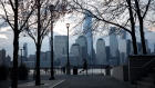 A jogger passes in front of buildings on the Lower Manhattan skyline along the waterfront in Jersey City, New Jersey, U.S., on Tuesday, April 21, 2020. Treasury futures ended Tuesday mixed, with front-end yields slightly cheaper on the day and rest of the curve richer, yet off session lows reached during U.S. morning. Photographer: Michael Nagle/Bloomberg