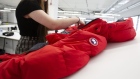 An employee checks a finished jacket at a Canada Goose manufacturing facility in Montreal, Canada.