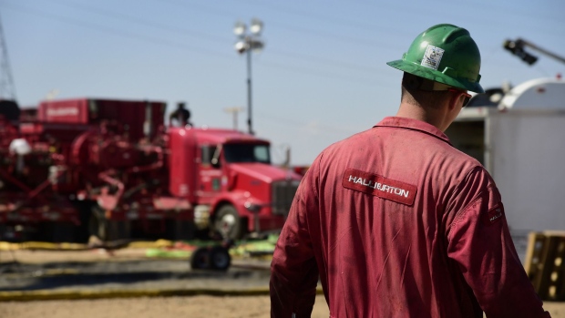 A Halliburton Co. worker walks through an Anadarko Petroleum Corp. hydraulic fracturing (fracking) site north of Dacono, Colorado, U.S.