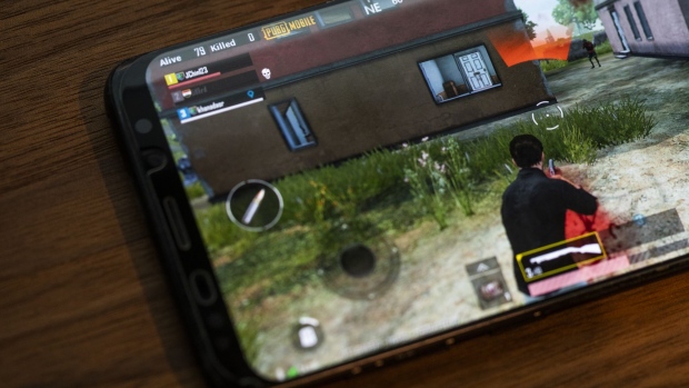 The PlayerUnknown's Battlegrounds (PUBG) game is displayed on a Samsung Electronics Co. Galaxy S9 Plus smartphone in an arranged photograph in Hong Kong, China, on Sunday, March 24, 2019. PUBG is a Hunger Games-style competition where 100 players face off with machine guns and assault rifles until only one is left standing. After China's Tencent Holdings Ltd. introduced a mobile version of the death match that's free to play, it has become the most popular smartphone game in the world, with enthusiasts from the U.S. to Russia to Malaysia.