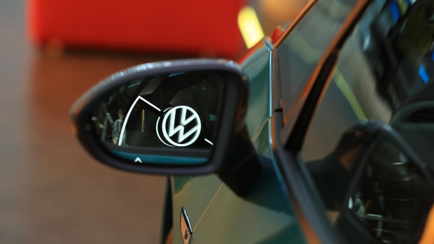 A Volkswagen (VW) logo is reflected in the wing mirror of a VW ID electric automobile. Photographer: Krisztian Bocsi/Bloomberg