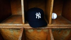 TAMPA, FL - FEBRUARY 25: A New York Yankees cap and a baseball are seen at Legends Field on February 25, 2005 in Tampa, Florida. (Photo by Ezra Shaw/Getty Images)