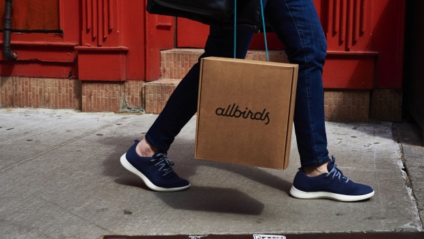 A shopper carries an Allbirds Inc. retail bag while walking in the SoHo neighborhood of New York, U.S., on Saturday, March 30, 2019. The U.S. Census Bureau released retail sales figures on April 1. Photographer: Gabby Jones/Bloomberg