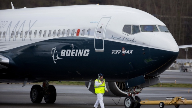 Crewman tow in a Boeing Co. Max 737 jet after landing at King County International Airport in Seattle, Washington, U.S., on Friday, Jan. 29, 2016. Boeing Co.'s newest 737 jetliner gunned its engines and headed into rain-streaked skies Friday, with profit and pride riding on its wings.