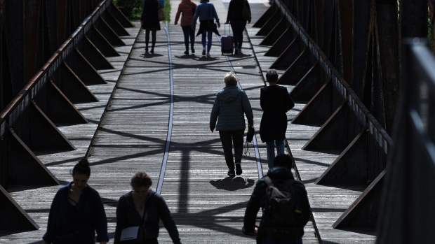 Pedestrians cross Zollbruecke bridge in Magdeburg, Germany, on Thursday, May 28, 2020. German Chancellor Angela Merkel’s government is preparing a bundle of measures to put Europe’s largest economy back on track after a nosedive triggered by the coronavirus pandemic.