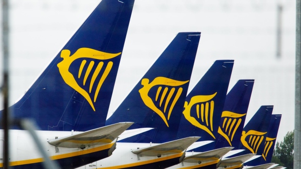 Tail-fins of passenger aircraft bearing the livery of Ryanair Holdings Plc stand on the tarmac at London Stansted Airport, operated by Manchester Airport Plc, in Stansted, U.K.