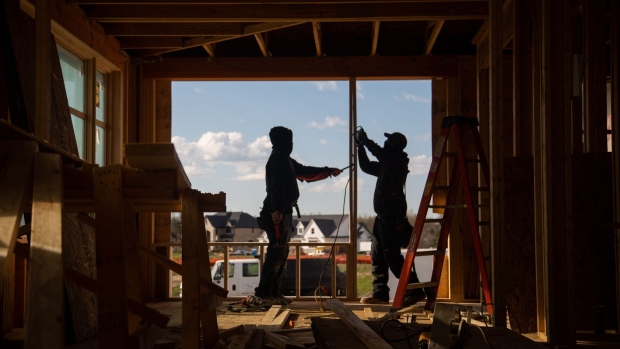 Construction workers install frames for windows and doors in a home being built in Michigan.