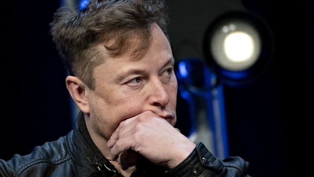 Elon Musk, founder of SpaceX and chief executive officer of Tesla Inc., listens during a discussion at the Satellite 2020 Conference in Washington, D.C., U.S., on Monday, March 9, 2020. The event comprises important topics facing both satellite industry and end-users, and brings together a diverse group of thought leaders to share their knowledge.