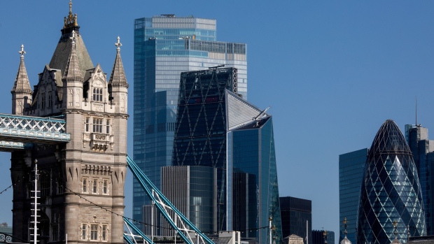 A tower on Tower Bridge stands in view of skyscrapers, including 22 Bishopgate, The Leadenhall Building, also known as The Cheesegrater, The Scalpel, and 30 St. Mary's Axe, also known as the Gherkin, stand In London, U.K., on Friday, July 31, 2020. London's best offices are forecast to plunge in value by as much as 15% this year as the coronavirus hits rents and investors' appetite for real estate. Photographer: Simon Dawson/Bloomberg