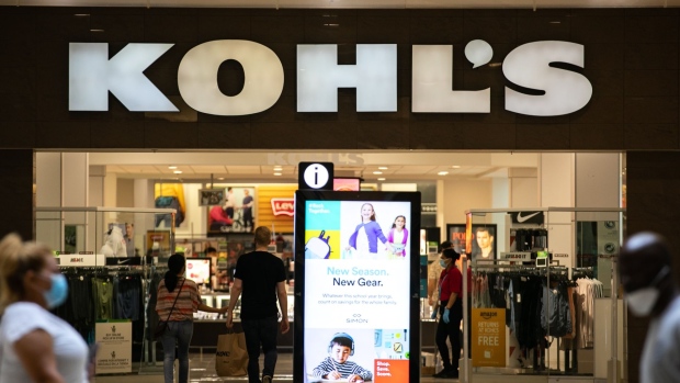 Shoppers wearing protective masks walk towards a Kohl's Corp. department store in Jersey City, New Jersey, U.S., on Friday, Aug. 14, 2020. Kohl's is scheduled to release earnings figures on August 18.