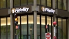 Traffic and pedestrians pass a Fidelity Investments office in Boston.