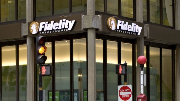 Traffic and pedestrians pass a Fidelity Investments office in Boston.