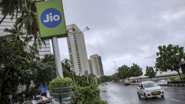 An advertisement for Jio Platforms Ltd., the mobile network of Reliance Industries Ltd., is displayed at Marine Drive in Mumbai, India, on Tuesday, July 14, 2020. Google is in advanced talks to buy a $4 billion stake in Jio, the digital arm of Indian billionaire Mukesh Ambani's conglomerate, people familiar with the matter said, seeking to join rival Facebook Inc. in chasing growth in a promising internet and e-commerce market.