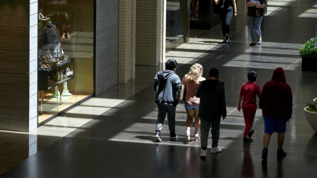 Shoppers walk through NorthPark Center mall in Dallas on May 1. Photographer: Cooper Neill/Bloomberg