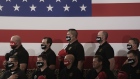 U.S. Border Patrol agents wearing "Trump" and "MAGA" protective masks participate in the pledge of allegiance during a campaign rally for U.S. President Donald Trump at Yuma International Airport in Yuma, Arizona, U.S., on Tuesday, Aug. 18, 2020. Trump portrayed Joe Biden as soft on illegal immigration in a speech Tuesday afternoon near the southern U.S. border, reprising a central theme of his 2016 campaign. Photographer: Bing Guan/Bloomberg