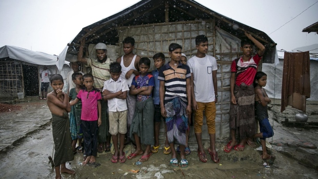 Rohingya stand during a rainstorm at the Nayapara refugee camp on August 21, 2019 in Cox's Bazar, Bangladesh.