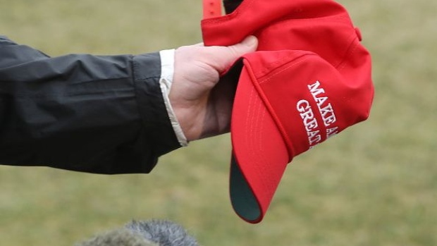 WASHINGTON, DC - MARCH 08: U.S. President Donald Trump holds a "Make America Great Again" hat as he speaks to the media before departing from the White House on March 8, 2019 in Washington, DC. President Trump is headed to Alabama to survey tornado damage. (Photo by Mark Wilson/Getty Images)