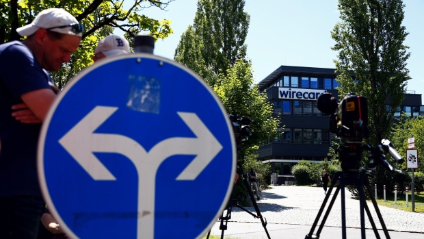 Television news crews gather outside the Wirecard AG headquarters during a police and prosecutors raid in Munich, Germany, on Wednesday, July 1, 2020. Wirecard offices in Germany and two locations in Austria were raided by Munich prosecutors looking into the 1.9 billion euros ($2.1 billion) that went missing from the fintech company’s accounts. Photographer: Michaela Handrek-Rehle/Bloomberg