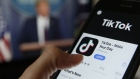 The TikTok app is displayed in the app store in this arranged photograph in view of a video feed of U.S. President Donald Trump in London, U.K., on Monday, Aug. 3, 2020. TikTok has become a flash point among rising U.S.-China tensions in recent months as U.S. politicians raised concerns that parent company ByteDance Ltd. could be compelled to hand over American users’ data to Beijing or use the app to influence the 165 million Americans, and more than 2 billion users globally, who have downloaded it. Photographer: Hollie Adams/Bloomberg