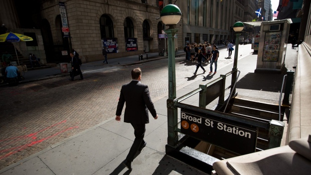 A pedestrian walks along Wall Street near the New York Stock Exchange.