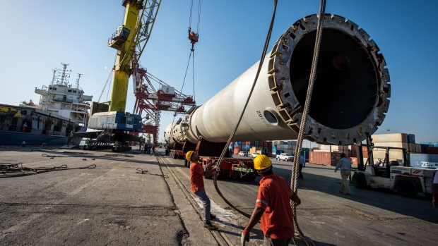Workers position a large section of steel tube onto a low loader on the dockside at Bandar Imam Khomeini (BIK) port in Bandar Imam Khomeini, Iran, on Thursday, May 23, 2019. Iranian officials have said that the raft of U.S. sanctions against their country, which was tightened last month, is aimed at fueling popular dissent in an effort to topple the leadership.