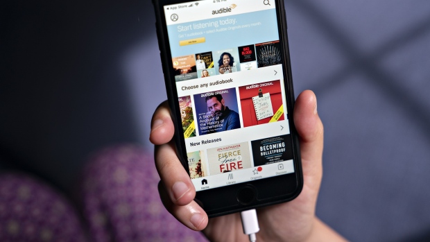 The Audible application is displayed on a smartphone in an arranged photograph taken in Arlington, Virginia, U.S., on Thursday, May 21, 2020. Audible's, the audiobook service owned by Amazon.com Inc., big push into the booming audio genre has confused some producers and podcast networks because it is happening at the same time that Amazon Music, a separate division of the e-commerce giant, is also ramping up its investment in podcasts. Photographer: Andrew Harrer/Bloomberg