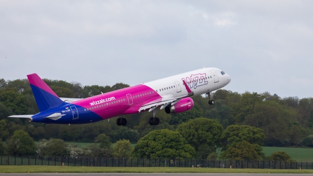 A passenger aircraft, operated by Wizz Air Holdings Plc, takes off as it departs from London Luton Airport in Luton, U.K., on Friday, May 1, 2020.Wizz Air plans to operate 10% of its scheduled flights for passengers with essential journeys from the airport today, the Evening Standard reports, citing the company. Photographer: Chris Ratcliffe/Bloomberg