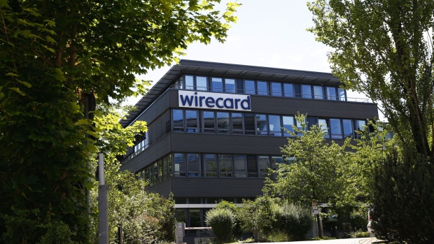 The Wirecard AG logo sits on the company's headquarters during a police and prosecutors raid in Munich, Germany, on Wednesday, July 1, 2020. Wirecard offices in Germany and two locations in Austria were raided by Munich prosecutors looking into the 1.9 billion euros ($2.1 billion) that went missing from the fintech company’s accounts.