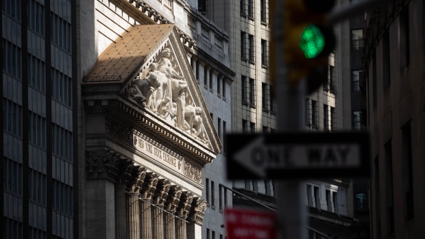 A streetlight stands in front of the New York Stock Exchange (NYSE) in New York, U.S., on Monday, July 20, 2020. U.S. stocks fluctuated in light trading as investors are keeping an eye on Washington, where lawmakers will begin hammering out a rescue package to replace some of the expiring benefits earlier versions contained.