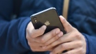 A customer views an Apple iPhone X. Photographer: Michael Short/Bloomberg