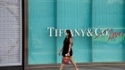 A pedestrian wearing a protective mask walks past a Tiffany & Co. luxury goods store in Singapore, on Monday, Feb. 10, 2020. Singapore last week raised its disease response level to the same grade used during the SARS epidemic, as it braced for what Prime Minister Lee Hsien Loong said was a “major test for our nation.” Photographer: SeongJoon Cho/Bloomberg