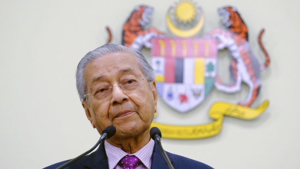Mahathir Mohamad, Malaysia's interim prime minister, pauses during an economic stimulus package launch event outside the Prime Minister's office in Putrajaya, Malaysia, on Thursday, Feb, 27, 2020. Malaysia, in the grip of a political leadership battle, announced a package of measures to counter the coronavirus outbreak, which will slow the country's economic growth this year.