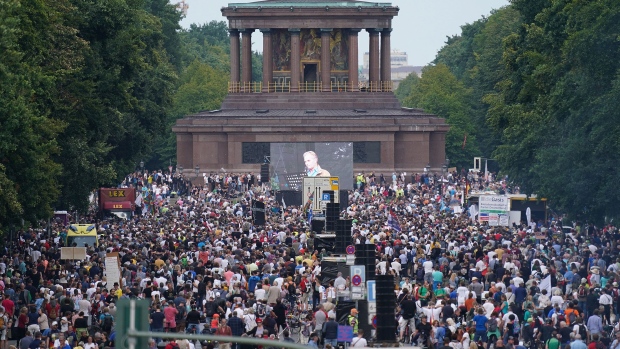 BERLIN, GERMANY - AUGUST 29: People gather at the Victory Column in the city center to hear speeches during a protest against coronavirus-related restrictions and government policy on August 29, 2020 in Berlin, Germany. Tens of thousands of people from a wide spectrum, including coronavirus skeptics, conspiracy enthusiasts, hippies, right-wing extremists, religious conservatives and others converged on Berlin to attend the protests. City authorities had banned the protests, citing the flouting of social distancing by participants in a similar march that drew at least 17,000 people a few weeks ago, but a court overturned the ban. (Photo by Sean Gallup/Getty Images)
