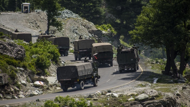 GAGANGIR, KASHMIR, INDIA - JUNE 19: An Indian army convoy drives towards Leh, on a highway bordering China, on June 19, 2020 in Gagangir, India. As many as 20 Indian soldiers were killed in a "violent face-off" with Chinese troops on Tuesday in the Galwan Valley along the Himalayas. Chinese and Indian troops attacked each other with batons and rocks. This is the deadliest clash since the 1962 India-China war and both have not exchanged gunfire at the border since 1967. Since the recent clash, there has been no sign of a breakthrough. India said its soldiers were killed by Chinese troops when top commanders had agreed to defuse tensions on the Line of Actual Control, the disputed border between the two nuclear-armed neighbours. China rejected the allegations. It blamed Indian soldiers for provoking the conflict, which took place at the freezing height of 14,000 feet. The killing of soldiers has led to a call for boycott of Chinese goods in India. On Thursday, thousands of people attended the funerals of the 20 slain Indian soldiers. To show their anger, Indians burnt Chinese flags and posters of China's President Xi Jinping in many states. (Photo by Yawar Nazir/Getty Images)