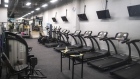 Treadmills and other fitness equipment stand inside a gym, temporary closed due to the coronavirus, in Hong Kong, China, on Saturday, March 28, 2020. Hong Kong announced plans to ban gatherings of more than four people and close cinemas, gyms and arcades, after the Asian financial center recorded its largest one-day surge in coronavirus cases on March 27.