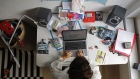 A woman works at an Apple Inc. laptop computer on a desk in a children's bedroom in this arranged photograph taken in Bern, Switzerland, on Saturday, Aug. 22, 2020. The biggest Wall Street firms are navigating how and when to bring employees safely back to office buildings in global financial hubs, after lockdowns to address the Covid-19 pandemic forced them to do their jobs remotely for months. Photographer: Stefan Wermuth/Bloomberg