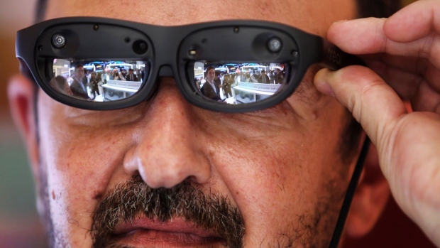 An attendee wears a pair of Nreal light mixed reality (MR) glasses on the LG Electronics Inc. stand on the opening day of the MWC Barcelona in Barcelona, Spain, on Monday, Feb. 25, 2019. At the wireless industry’s biggest conference, over 100,000 people are set to see the latest innovations in smartphones, artificial intelligence devices and autonomous drones exhibited by more than 2,400 companies. Photographer: Angel Garcia/Bloomberg