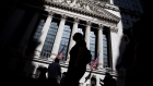 Pedestrians pass in front of the New York Stock Exchange (NYSE) in New York, U.S., on Friday, May 24