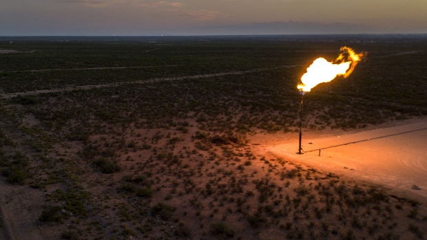 A gas flare is seen at dusk in this aerial photograph taken above a field near Mentone, Texas. Photographer: Bronte Wittpenn/Bloomberg